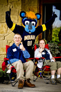 Two Noble participants giving thumbs up with The Pacer's mascot, Boomer, cheering behind them.