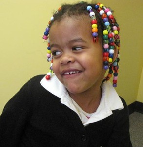 Kari smiling with beads in her hair.