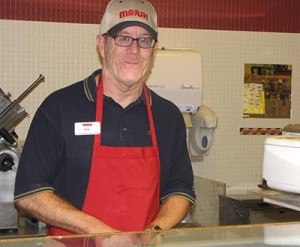 Noble participant at work at a Marsh deli counter.