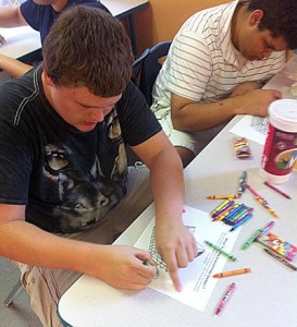 Boy filling out worksheet during Skills for Life Camp