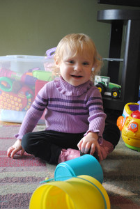 Toddler playing with toys on the floor