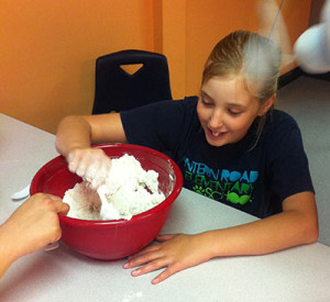 Young Noble participant mixing something in a large bowl.