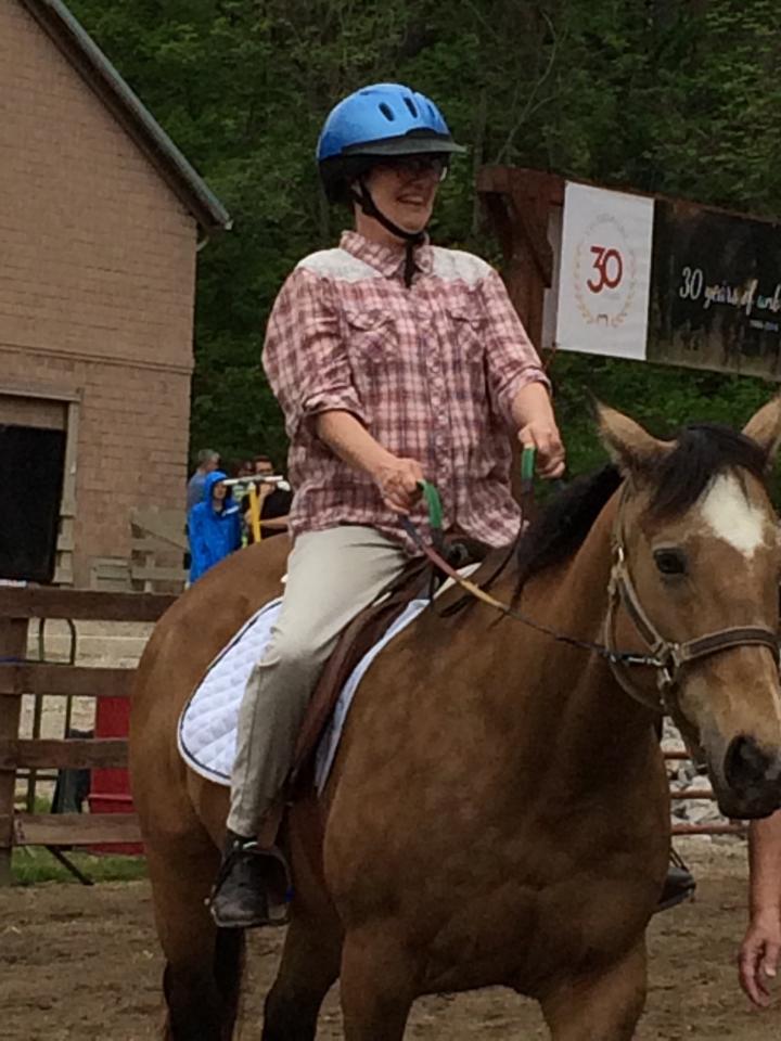 Cathy competing in a horseback riding event