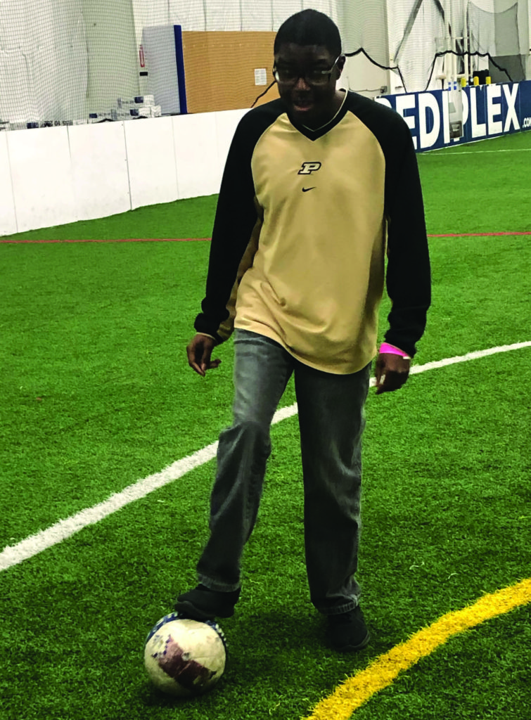 Tyrese enjoys working on his soccer skills during Rec Therapy 