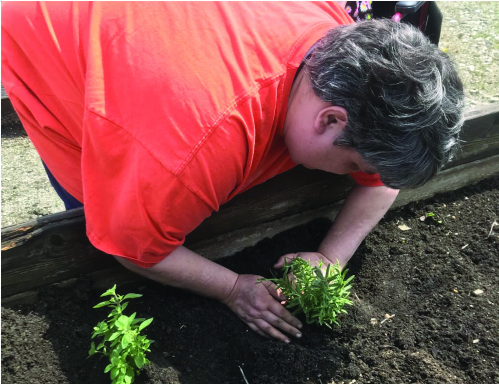 Sarah is exercising her Green Thumb in our Giving Sum Garden