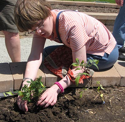 Liz gardening in our Giving Sum Garden.