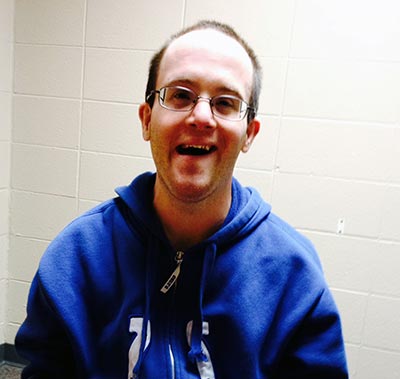 Nathan smiling for the camera wearing a Colts sweatshirt.