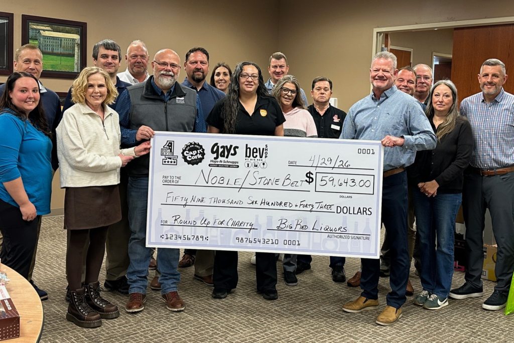 Big Red presents Noble with a generous check